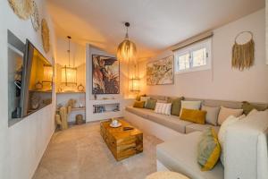 a living room with a couch and a table at Oceania Villa Private Pool Garden in Chayofa