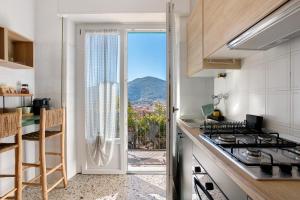 a kitchen with a view of a mountain at Ca' Montello Apartment in La Spezia
