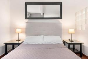 - une chambre avec un lit et 2 tables avec des lampes dans l'établissement Confortable estudio en Playa Los Baños del Carmen, à Malaga