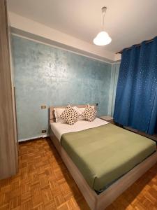Un dormitorio con una cama con paredes azules y cortinas azules. en Venice casa, en Mestre
