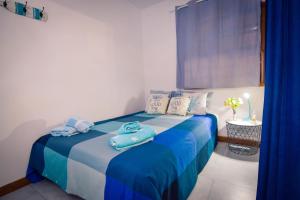 a bedroom with a blue bed with towels on it at Wonderful Bungalow in Maspalomas in Maspalomas +18 photos