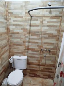 a bathroom with a toilet and a shower at Habitación para 3 in Belén +2 photos