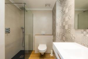 a bathroom with a toilet and a glass shower at Apartament Massanet 2b in Canyamel +17 photos