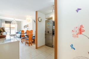 a kitchen and dining room with a table and chairs at Apartment Verano Go2lloret in Lloret de Mar