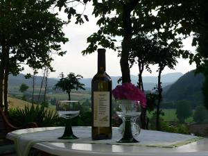 a bottle of wine sitting on a table with two glasses at Ferienwohnung Ritter in Oberharmersbach +8 photos