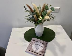 a vase of flowers sitting on top of a table at Ferienwohnung Nele in Plettenberg +19 photos