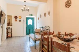 a dining room with a table and a green door at Peaceful Refuge In Mani 2 in Kótronas