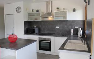 a kitchen with a sink and a counter top at Appartement T3 in Embrun