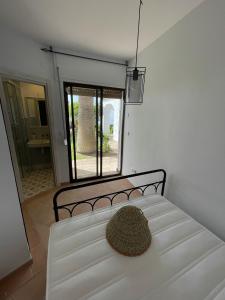 a bed with a hat sitting on top of it at Villa Tropical Dream in Salobreña +17 photos