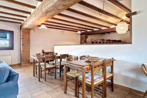 a dining room with wooden tables and chairs at Casa Entera Cal Tous in Rojals +21 photos