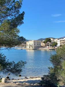 a view of a large body of water with a building at Casa vacacional Es Port in Portocolom +73 photos