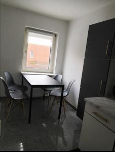 a room with a table and chairs and a window at Wohnung am Bahnhof Schwerte in Schwerte