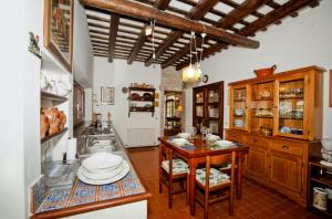 a kitchen with wooden cabinets and a wooden table at Italian Experience-Villa Incanto in Potenza Picena