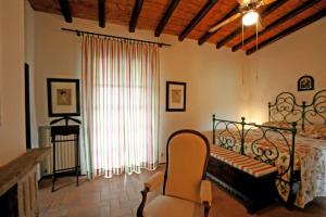 a bedroom with a bed and a chair and a window at Italian Experience-Villa Incanto in Potenza Picena