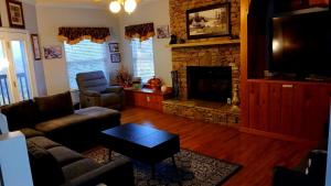 a living room with a couch and a fireplace at Carebear 2 in Gatlinburg