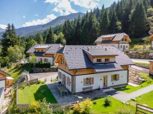 an aerial view of a house with mountains in the background at Im grünen Herzen in Donnersbachwald