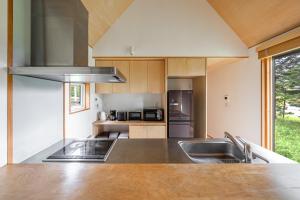 a kitchen with a sink and a stove at Poroto House in Nanae +156 photos