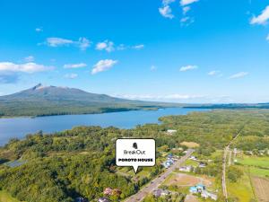 a view of a lake with a mountain in the background at Poroto House in Nanae