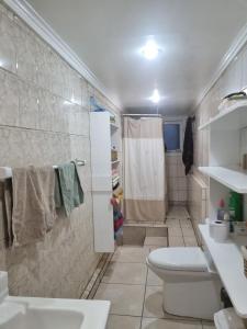 a bathroom with a toilet sink and a shower at Comfortable and family house in Cerro Alegre in Valparaíso