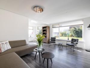 a living room with a couch and chairs at Bollenzicht in Breezand