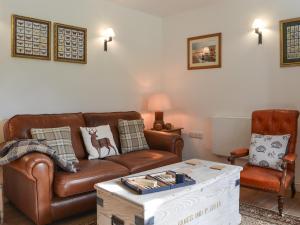 a living room with a couch and a coffee table at Grattan Cottage in Bow