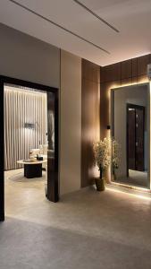 a lobby with a large mirror and a living room at روف in Al Hofuf