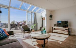 a living room with a couch and a tv at Oostergeest 3 6P in Uitgeest