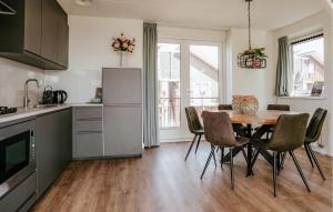 a kitchen and dining room with a table and chairs at Oostergeest 3 6P in Uitgeest