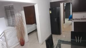 a living room with a refrigerator and a kitchen at 03 Aires Acondicionados in Cúcuta