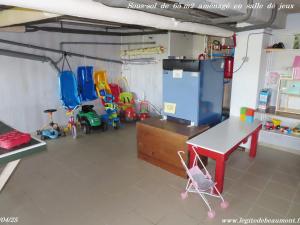 a room with a table and chairs and a refrigerator at Charmant Gîte 4* dans un Hameau Paisible des Vosges - FR-1-583-388 in Fougerolles
