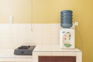 a kitchen with a bottle of water on a counter at RedDoorz at Hotel Galuh Putra Pangandaran in Pangandaran