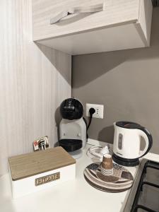 a kitchen counter with a coffee maker and a box at Da Nonno Mario in Bagnoli Irpino