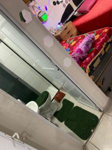 a glass display case in a room with a bed at Pousada Duda Lins in São Vicente