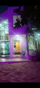 a building with purple lights on the side of it at Casaquinta Con Piscina in Villeta