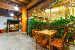 een tafel en stoelen in een restaurant met planten bij The Peak Living in Shangri-La