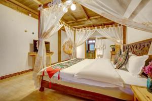a bedroom with a large bed with a canopy at The Peak Living in Shangri-La
