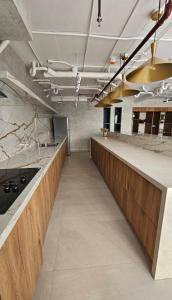 a large kitchen with wooden counters and a counter top at Cozy & Modern Apartment in Lirios de Miraflores in Tegucigalpa