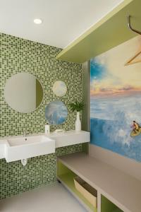 a bathroom with a sink and a painting on the wall at Ion Bali Benoa in Nusa Dua