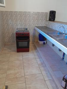 a kitchen with a counter and a stove and a sink at Apparemment à louer au trois ilets en Martinique in Les Trois-Îlets