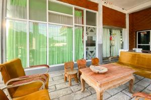 a living room with a wooden table and chairs at Merapi Hill Homestay Syariah Selo RedPartner in Selo