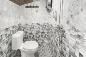 a bathroom with a toilet and a shower at Merapi Hill Homestay Syariah Selo RedPartner in Selo +17 photos