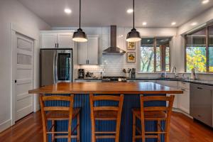 a kitchen with a large island with bar stools at Evergreen Retreat AB 30 Night Minimum home in White Salmon