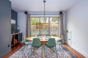 a dining room with a table and chairs and a window at Evergreen Retreat AB 30 Night Minimum home in White Salmon +47 photos