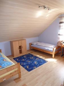 a room with two beds and two rugs in it at Ahornweg Ferienwohnung in Gebsattel