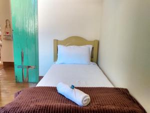 a bed in a room with a towel on the floor at Hostel da Dri in Aiuruoca