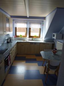 a kitchen with a sink and a table at Ahornweg Ferienwohnung in Gebsattel