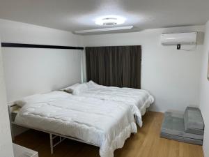 Postel nebo postele na pokoji v ubytování フレグランスショーワ