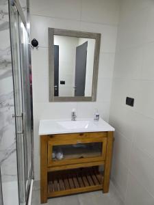 a bathroom with a sink and a mirror at Sol del Atardecer in Rada Tilly