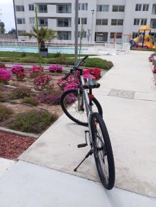a bike parked on a sidewalk next to a building at Jardines del Pacifico in El Cerrillo