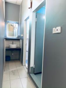 a bathroom with a sink and a mirror at Prima B&B Hostel in Sandakan +64 photos